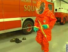 Atlanta firefighter Earl Powell shows how ackward current protective suits are. 