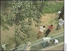 Security officials tackle would-be defectors as they try to scale the fence