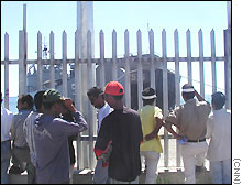 Crowds watch the Indonesian warship cautiously