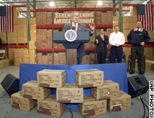 President Bush stands in front of boxes which had 