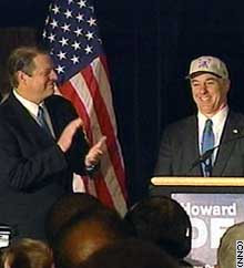 Al Gore applauds Howard Dean on Tuesday before announcing his endorsement of the former Vermont governor at a rally in Harlem.
