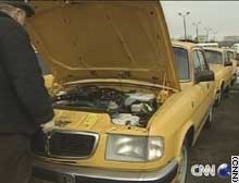 GAZ company's engineer tries to keep the Volga taxi motors in running order.