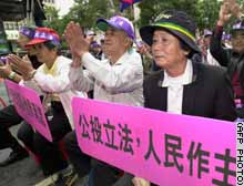 Pro-independence supporters march in Taiwan ahead of a controversial vote.