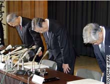 Ashikaga Bank directors bow as they acknowledge the bank's insolvency.
