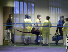 Masks are now a common sight at airports in Asia.