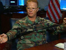 Army Master Sgt. Michael Brochu demonstrates the one-handed tourniquet.