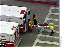 Rescuers in this July 2002 photo remove one of the victims from the Los Angeles terminal.