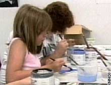 Kids make tiles for the memorial at Columbine High School.