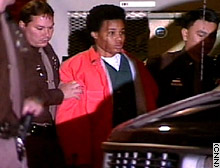 Officers escort Lee Boyd Malvo after a court appearance.