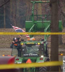 Watson waved an American flag Monday from the tractor he drove on the grounds near the Washington Monument. 