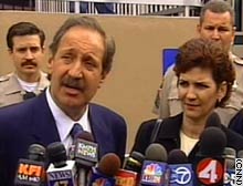 Mark Geragos, left, speaks to reporters following Friday's court hearing.