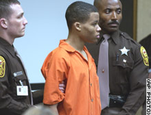 Sniper suspect Lee Boyd Malvo is surrounded by deputies as he is brought into court on October 22 to be identified by a witness during John Allen Muhammad's trial.