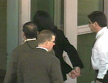 Jackson arrives in handcuffs at the sheriff's department.