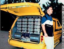 Troy Irving and his Dodge Caravan, which has 72 daisy-chained Ample Audio 1500 DX amps 