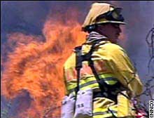 A fireman fights a wildfire in Colorado in 2002.