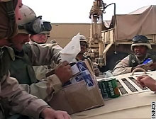 A serviceman opens a package from home.
