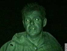 CNN's Martin Savidge reports using a night scope, which reflects in his eyes. 