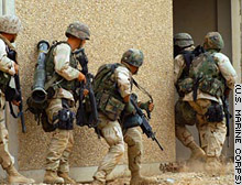 Marines enter a building during an April 8 raid on a compound in Iraq.