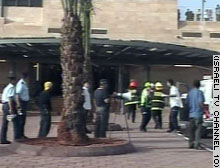 A crowd gathers at the new train station in Kfar Saba, the site of the suicide bombing.