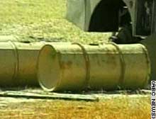 Material from these and other 55-gallon drums is being tested for suspected chemical agents.