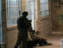 An Israeli soldier guards Palestinians  Wednesday in Ramallah.