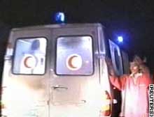 An ambulance leaves the scene of an ambush in which seven Spanish intelligence agents died Saturday.